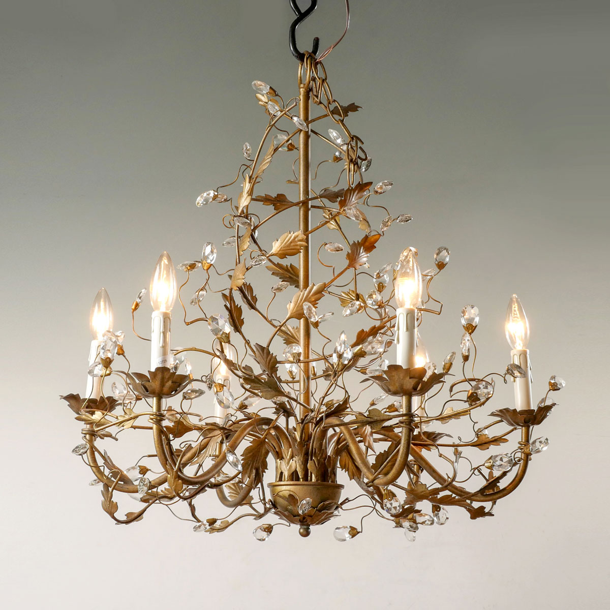 Appraisal: LIGHT METAL CRYSTAL CHANDELIER scrolling arms attached metal leaf form