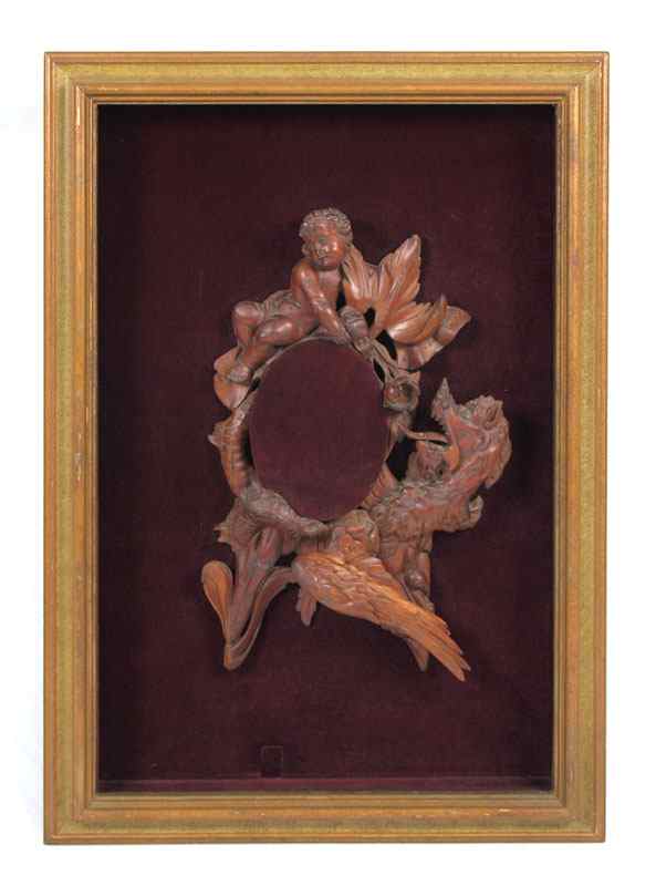 Appraisal: CARVED PUTTI AND DRAGON FRAGMENT Mounted on velvet in deep