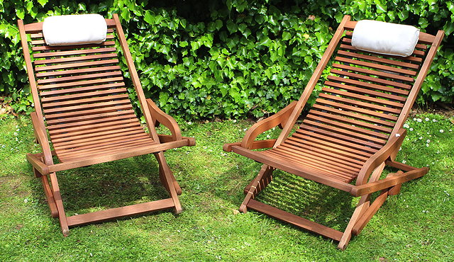 Appraisal: TWO FCS TEAK DECKCHAIRS with slatted backs