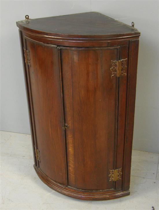 Appraisal: George III oak bow fronted corner wall cupboard h w