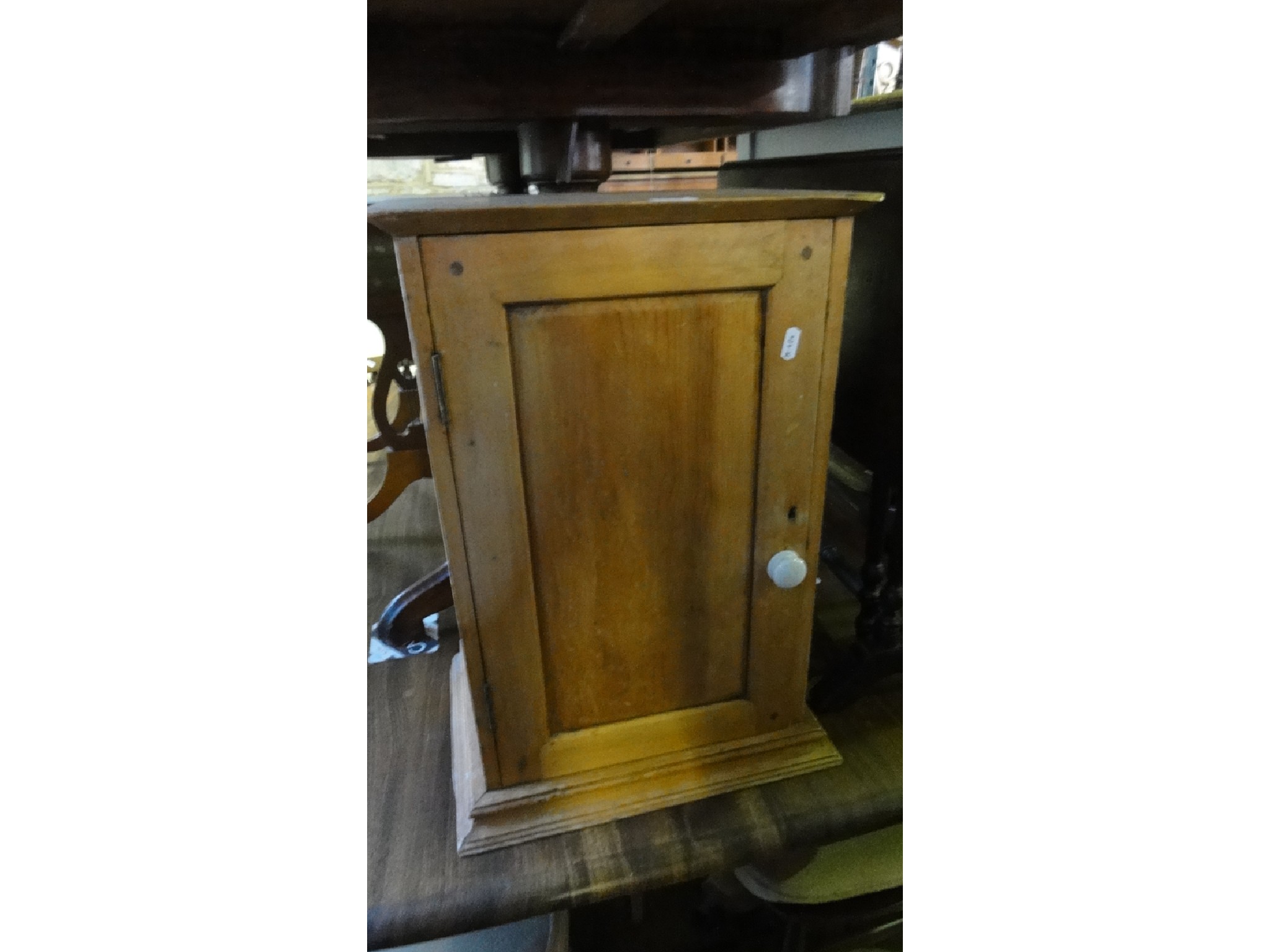 Appraisal: A small vintage stripped pine wall mounted bathroom cabinet enclosed