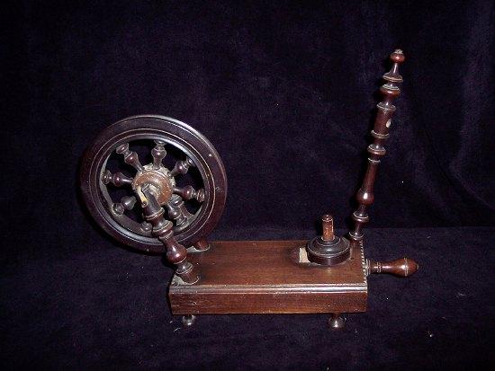 Appraisal: A table spinning wheel in cherrywood with turned spindle and