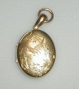 Appraisal: An oval yellow metal locket with crane and water bird