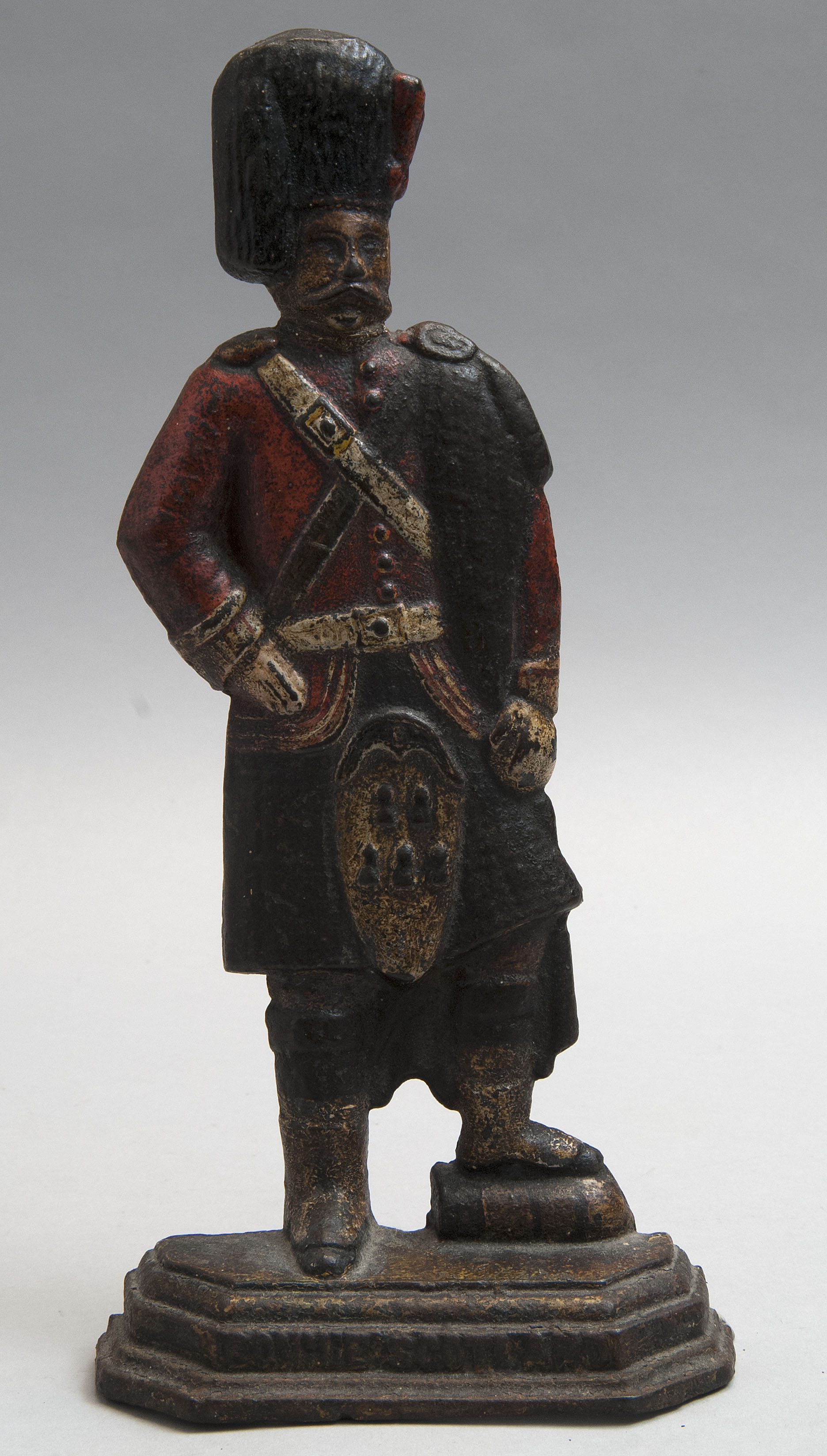 Appraisal: COLD-PAINTED CAST IRON SCOTSMAN DOORSTOP th CenturyA polychrome-decorated standing figure