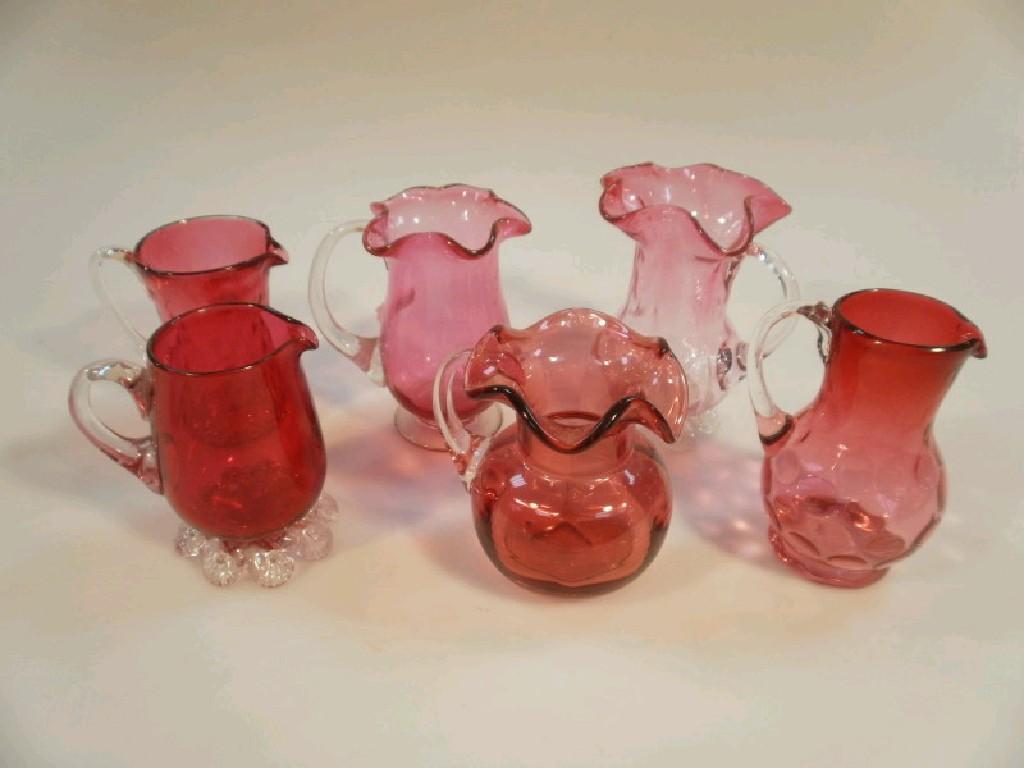 Appraisal: Six Cranberry glass jugs