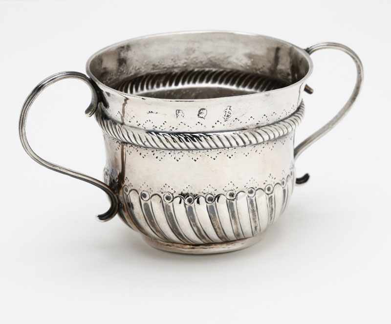 Appraisal: A Queen Anne Britannia silver caudle cup London with partial