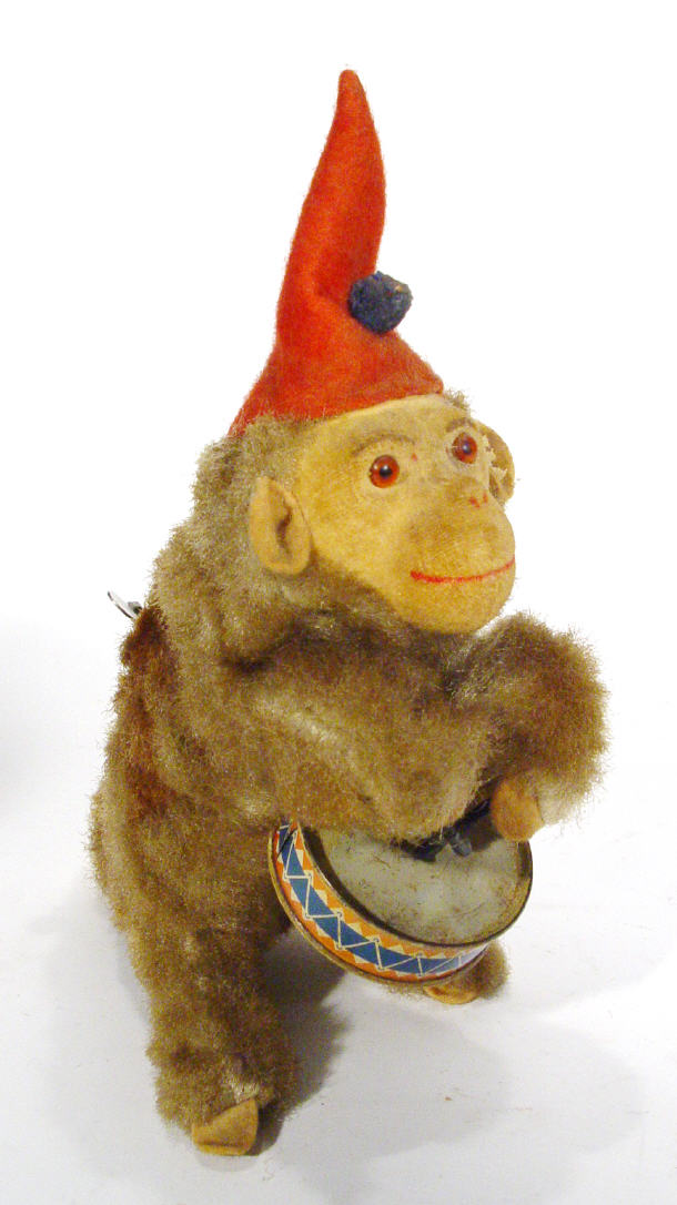 Appraisal: Clockwork drumming monkey with felt face cm high