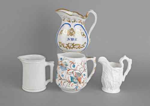 Appraisal: Two painted porcelain pitchers together with two white ironstone pitchers