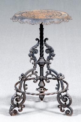 Appraisal: Ornate iron stand top with scrolls in relief above tripod