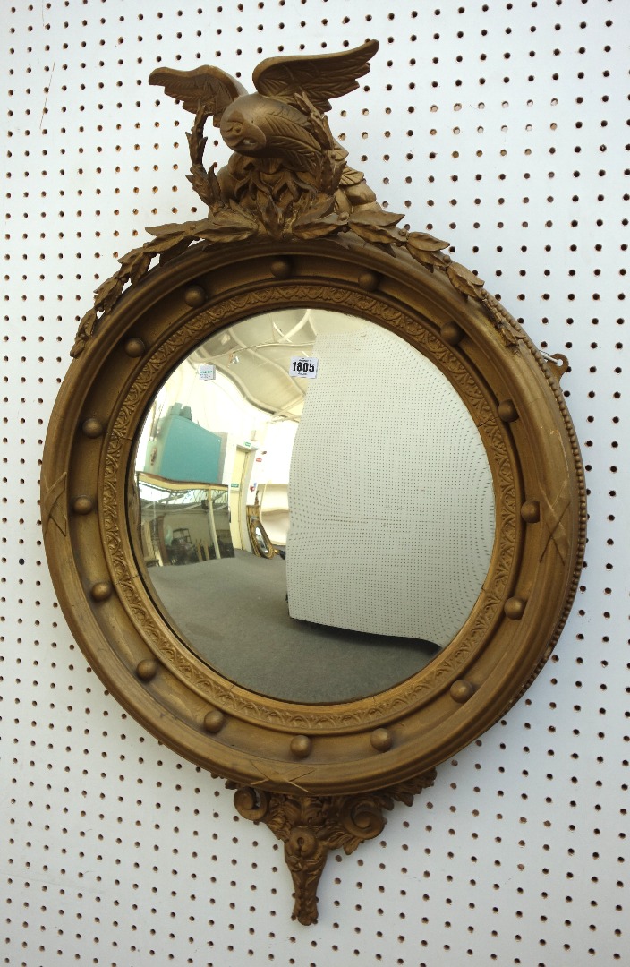 Appraisal: A Regency style gilt framed convex wall mirror with eagle