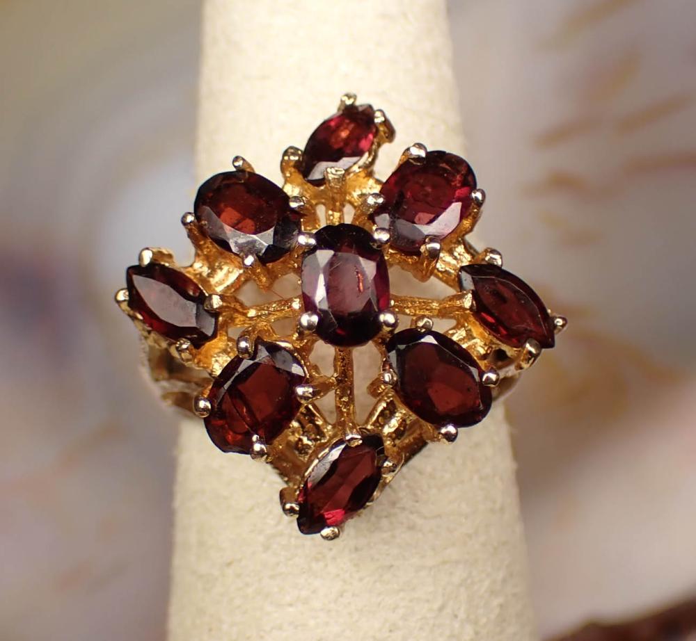 Appraisal: GARNET AND FOURTEEN KARAT GOLD RING The yellow gold ring