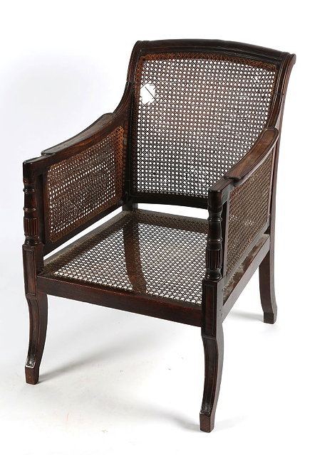 Appraisal: A GEORGE III SIMULATED ROSEWOOD BERGERE LIBRARY CHAIR with cane