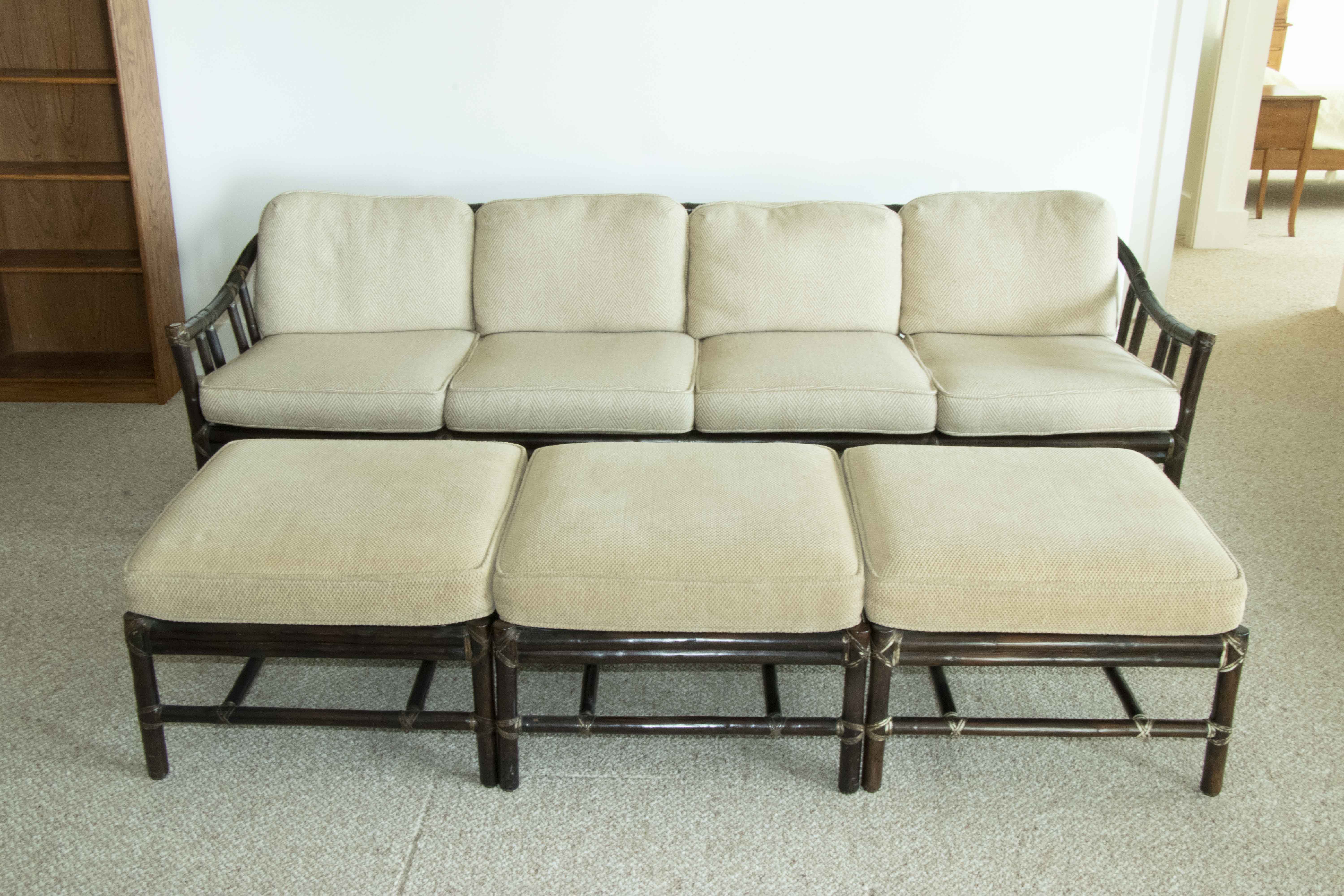 Appraisal: SET OF RATTAN SOFAS WITH OTTOMANS Two dark-stained rattan sofas