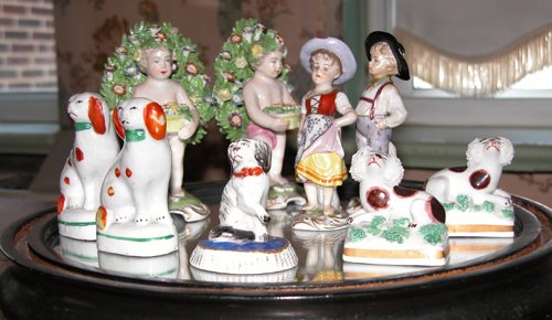 Appraisal: Title Set of Porcelain dog figurines with bocage figures and