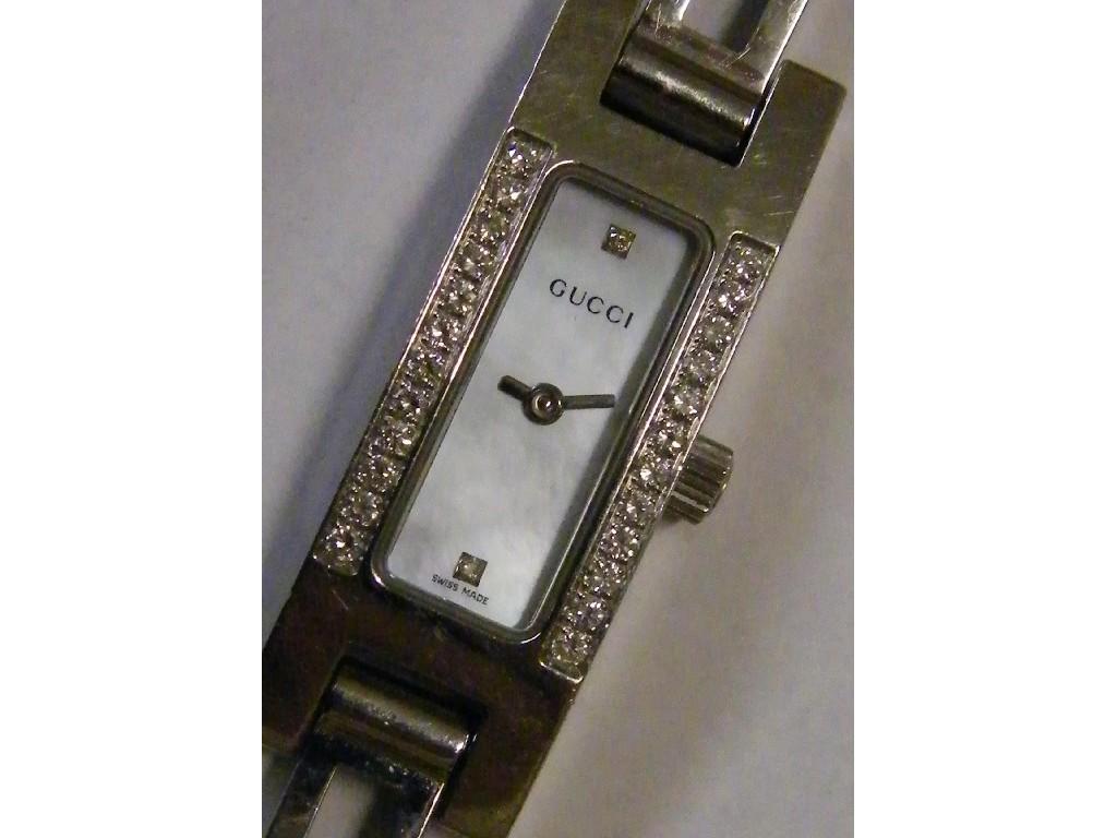 Appraisal: - -A Gucci diamond set lady's bracelet watch with spare