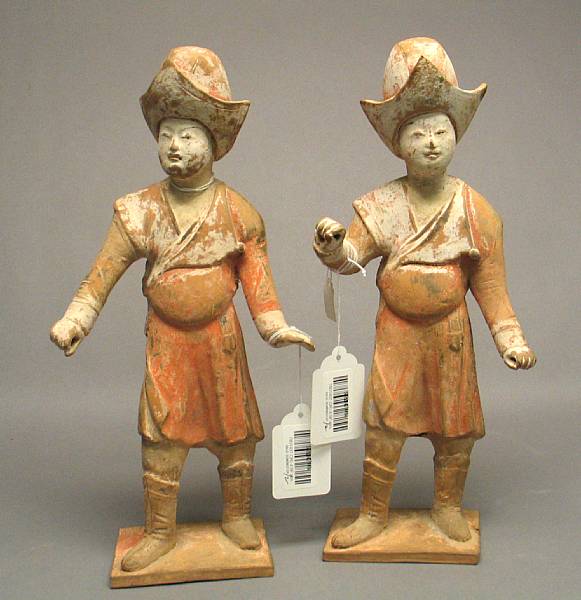 Appraisal: A pair of Tang style painted pottery grooms Each standing