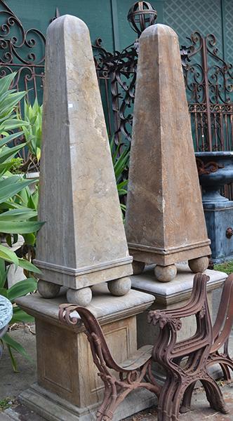 Appraisal: A PAIR OF STONE OBELISKS ON STANDS each of tapering