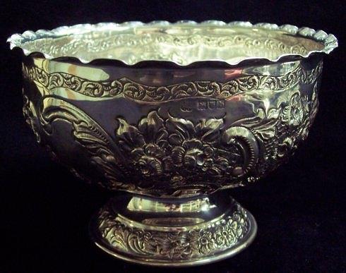 Appraisal: A circular rosebowl chased with flowers and scrollwork and raised