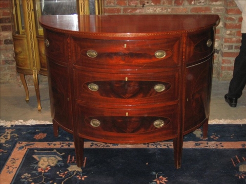 Appraisal: GEORGE III STYLE MAHOGANY DEMI-LUNE CHEST th c the bellflower