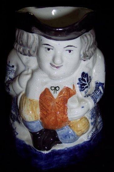 Appraisal: A Staffordshire Toby jug the figure wearing a willow pattern