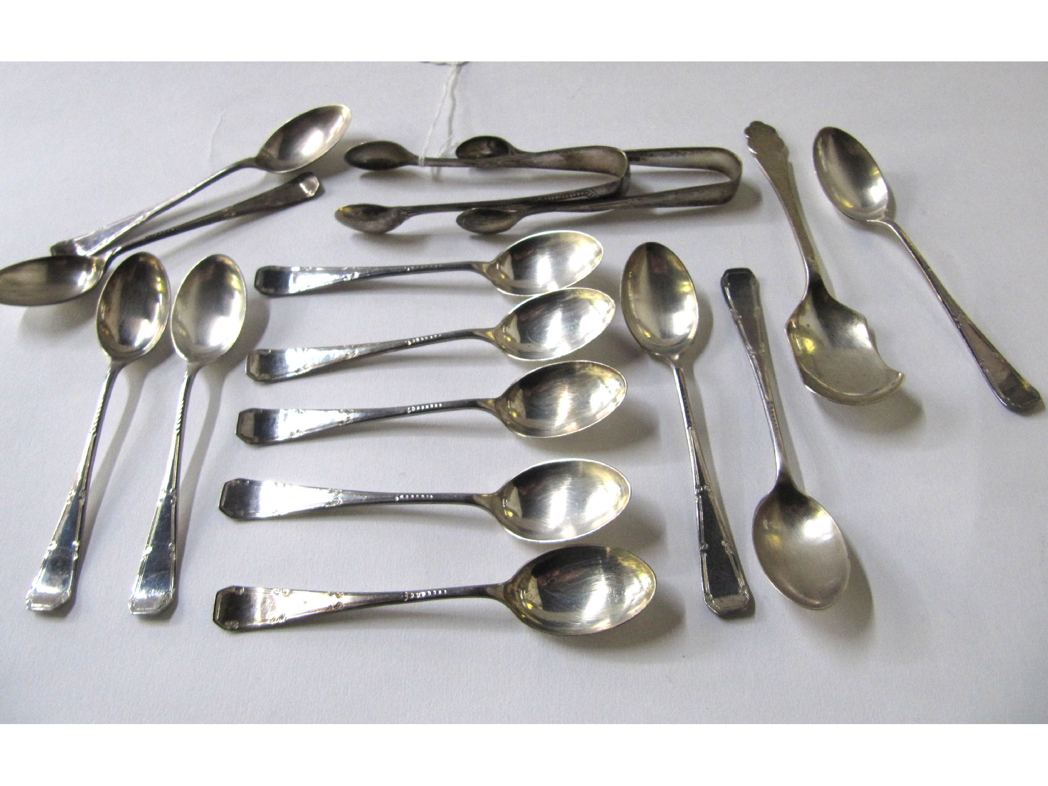 Appraisal: A lot comprising assorted silver teaspoons and sugar tongs assorted