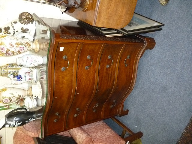 Appraisal: A GEORGE III STYLE MAHOGANY SERPENTINE CHEST of four long