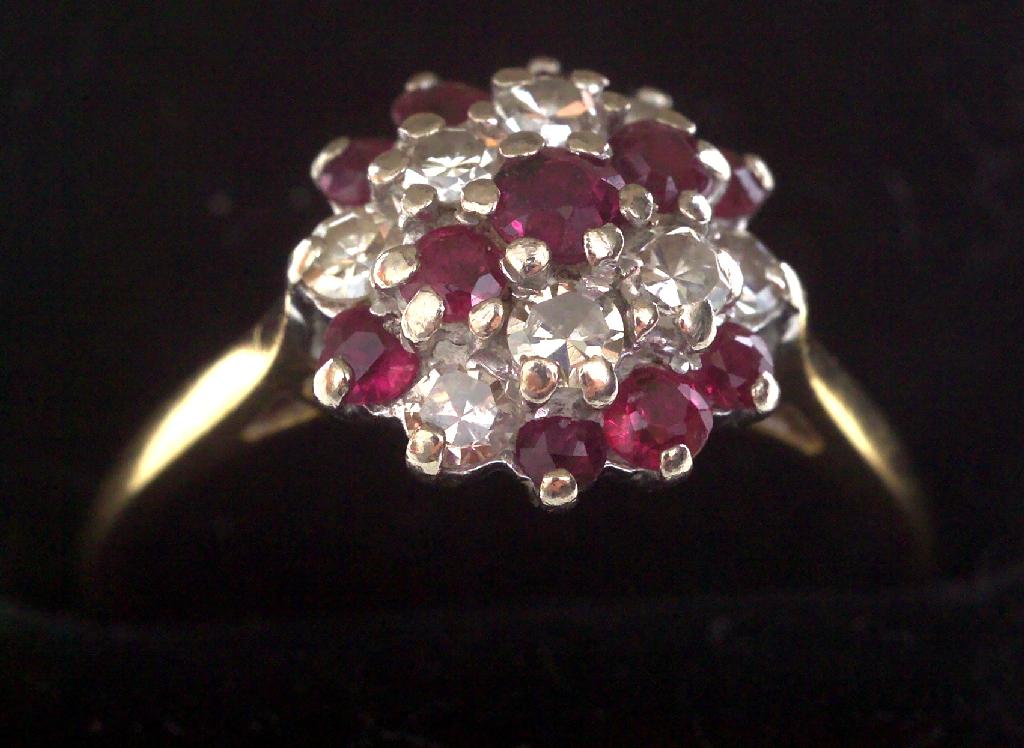 Appraisal: MODERN RUBY AND DIAMOND CLUSTER RING set with two bands