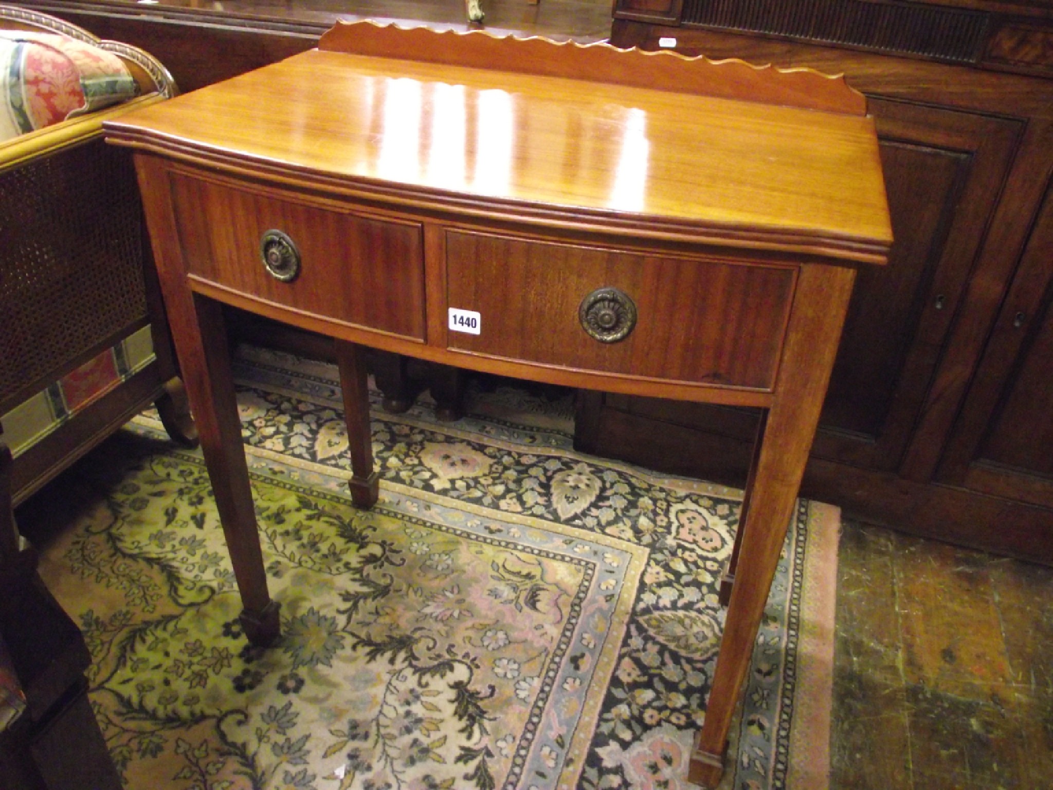 Appraisal: A Georgian style side table with bow fronted outline enclosing