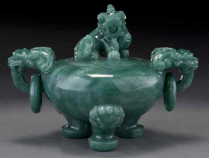 Appraisal: Chinese carved jade tripod censerwith two free rings ''H x