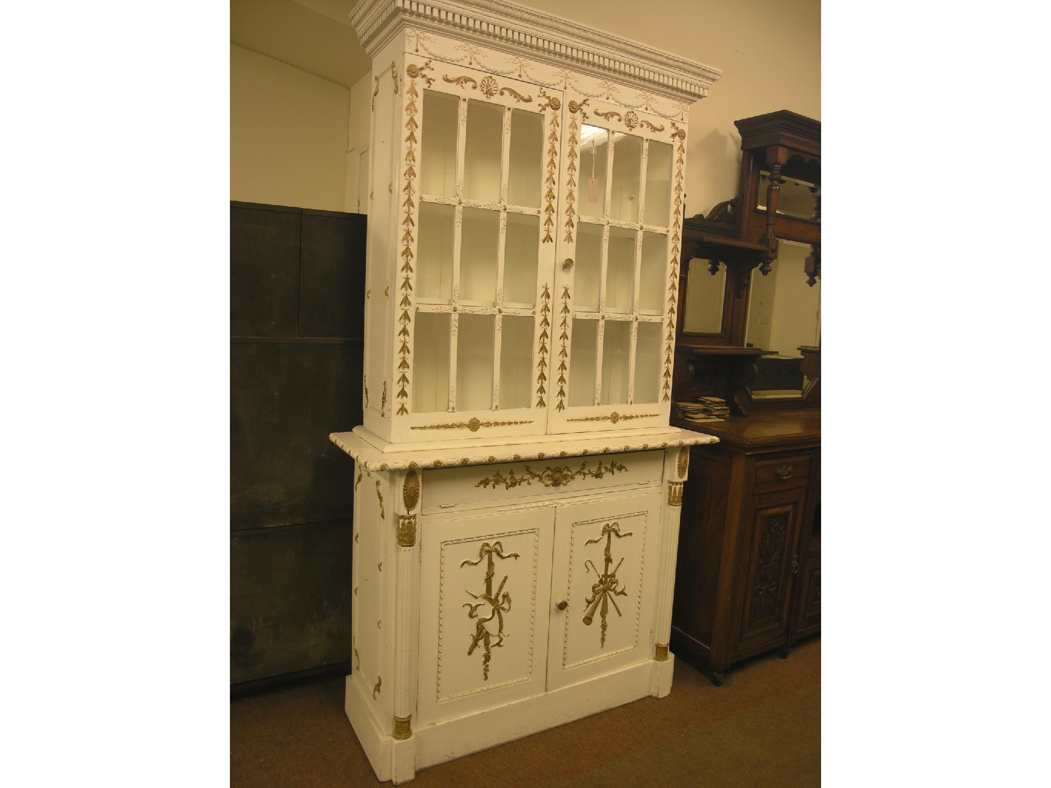 Appraisal: A French painted pine bookcase pair of glazed doors enclosing