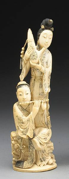 Appraisal: A carved ivory figural group of two palace musicians Dressed