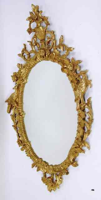 Appraisal: An oval wall mirror in a gilt plaster frame with