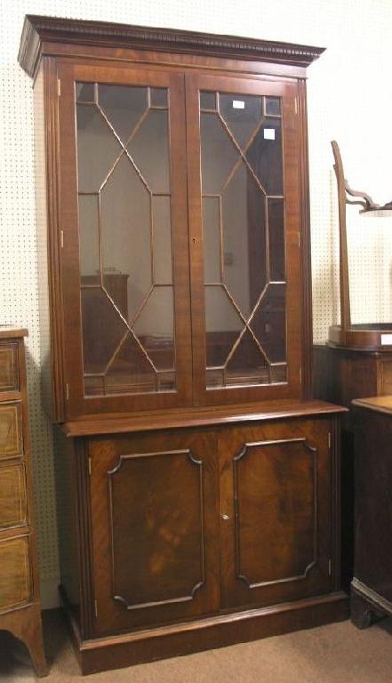 Appraisal: A reproduction mahogany bookcase pair of astragal glazed doors enclosing