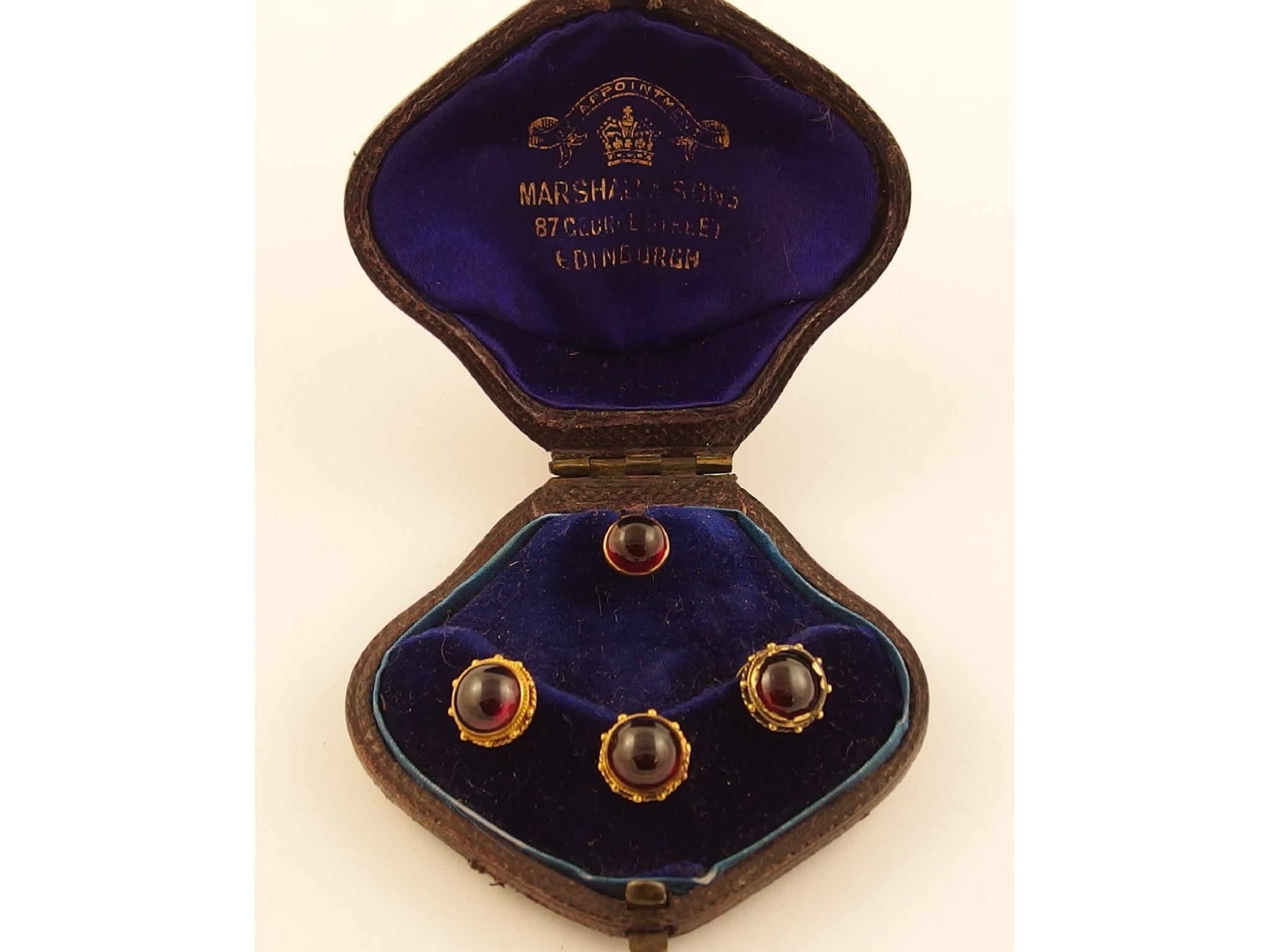 Appraisal: A set of four garnet dress studs one plain and