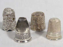 Appraisal: Four interesting white metal thimbles some test silver unmarked