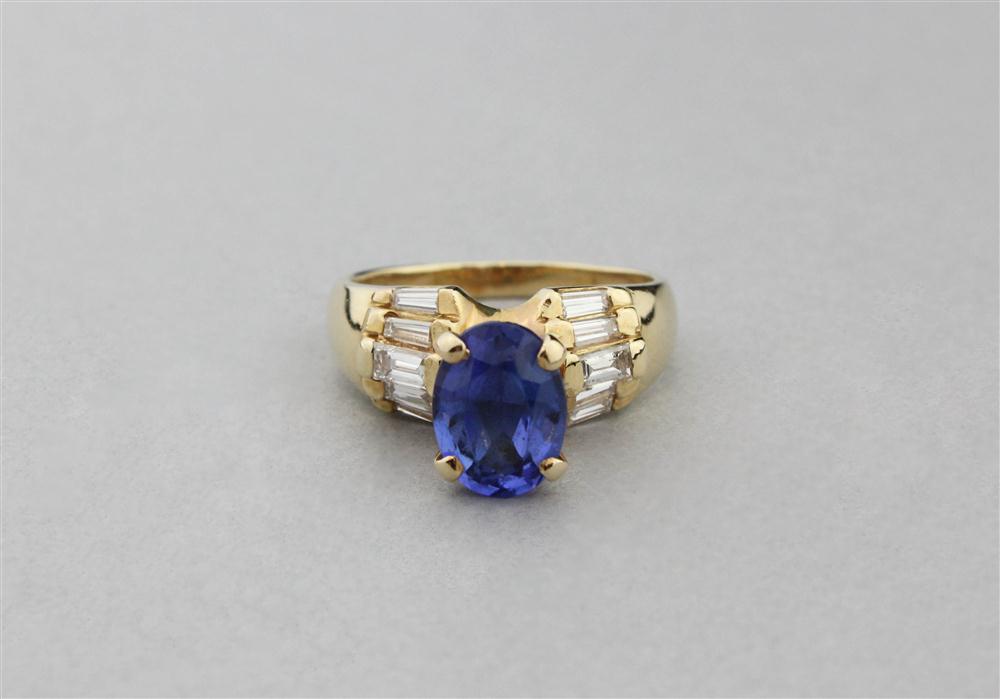 Appraisal: TANZANITE SOLITAIRE RING FLANKED BY DIAMOND BAGUETTES IN K GOLD