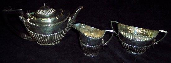 Appraisal: An oval half ribbed tea service monogrammed Sheffield