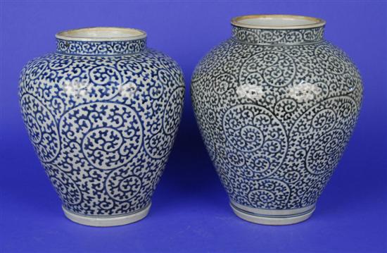 Appraisal: TWO JAPANESE BLUE AND WHITE SCROLL DECORATED BALUSTER VASES height