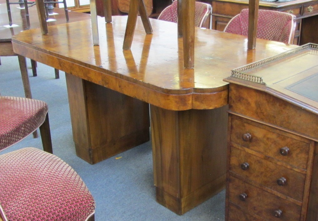 Appraisal: An Art Deco figured walnut dining room suite the shaped