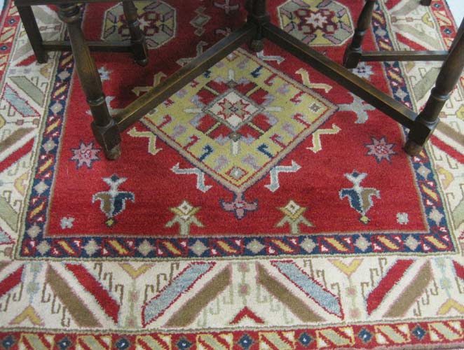 Appraisal: HAND KNOTTED ORIENTAL CARPET Indo-Kazak four geometric medallion design on