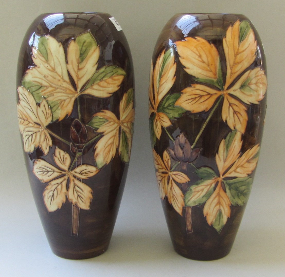 Appraisal: A pair of tall Moorcroft slender ovoid vases tube lined