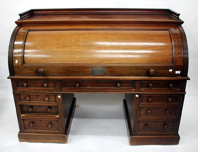 Appraisal: A VICTORIAN MAHOGANY ROLL TOP PEDESTAL DESK the roll top