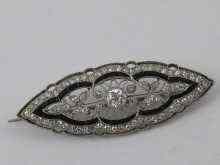 Appraisal: A fine white metal tests platinum diamond and onyx brooch