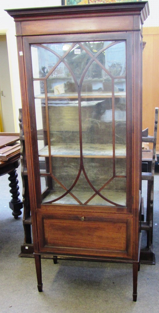 Appraisal: An Edwardian satinwood banded mahogany single door display cabinet on