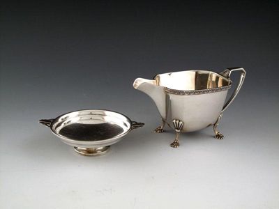 Appraisal: A silver cream jug by Mappin and Webb Sheffield panelled