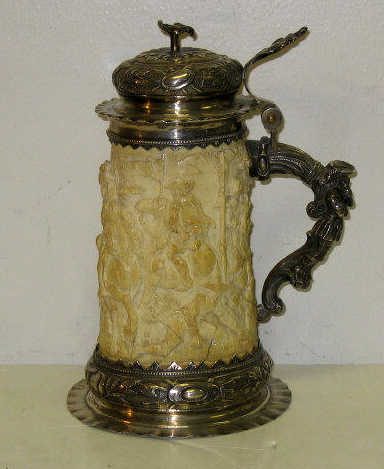 Appraisal: GERMAN SILVER MOUNTED IVORY TANKARD The ivory body carved with