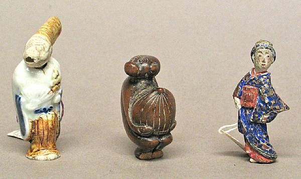 Appraisal: Three netsuke Including one carved wood monkey carrying a peach