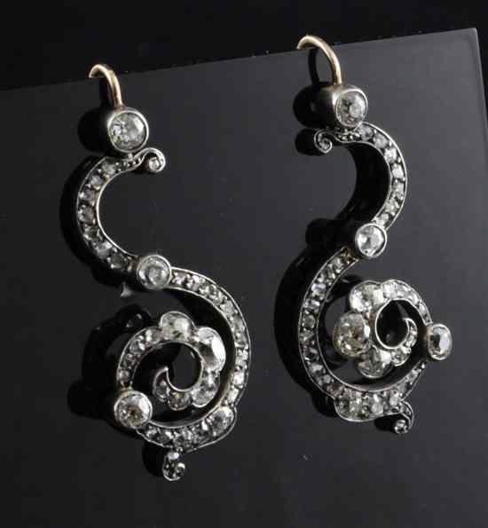 Appraisal: A pair of antique diamond set gold scroll drop earrings