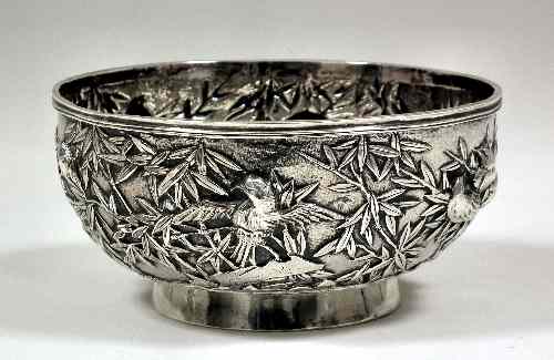 Appraisal: A Chinese silvery metal circular bowl embossed with birds amongst