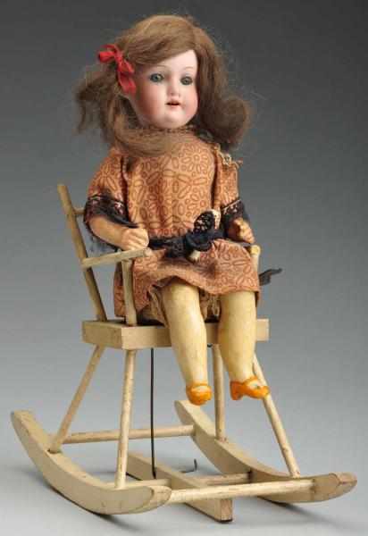 Appraisal: Mechanical Girl in Rocking Chair Description German bisque socket head